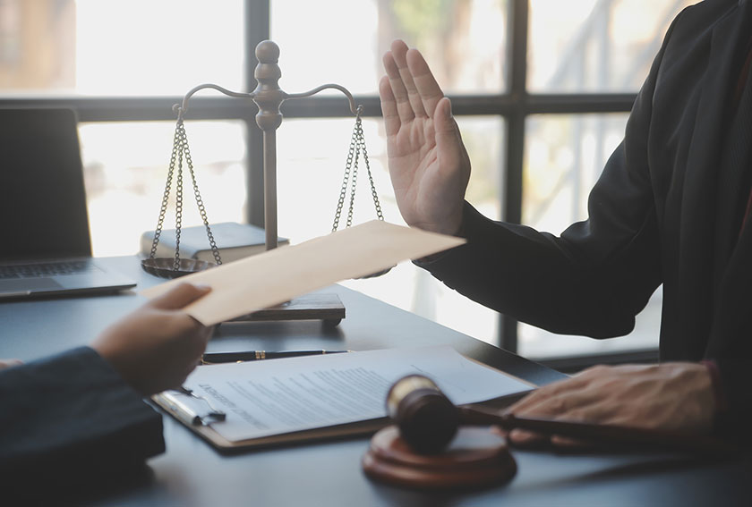 Attorney reviewing appellate documents beside a gavel in a courtroom setting, representing careful Maryland appeal preparation and strict filing deadlines.